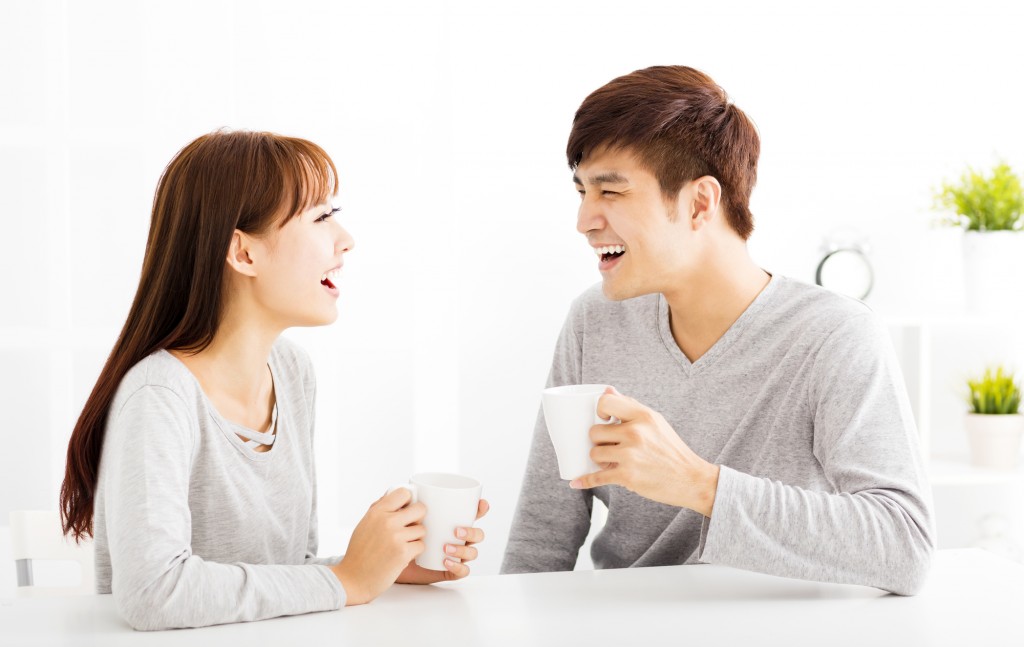 happy young Couple drinking coffee  In living room